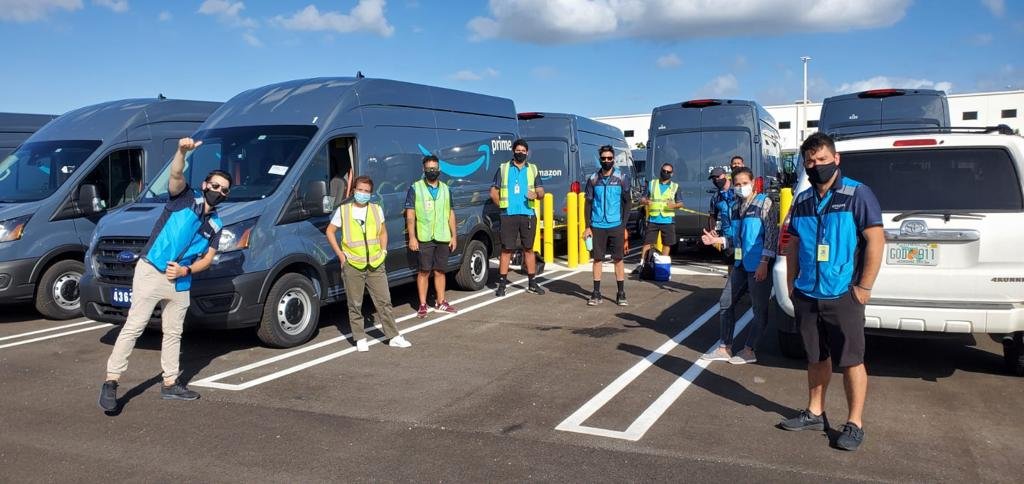 BOOZ driver team in front of the delivery vans