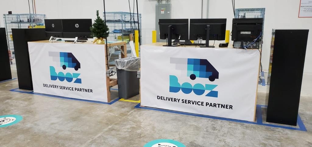 BOOZ office desks with the company logo at the station