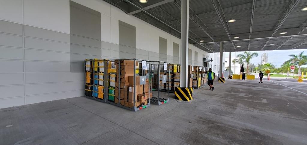 Carts with packages sorted by route at the station loading dock